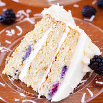 A cake for all occasions, this Blackberry Coconut Cake has a dense and moist crumb of blackberries and coconut, is filled with rich coconut buttercream, and frosted with tangy cream cheese frosting. Perfect for berry and coconut lovers everywhere.